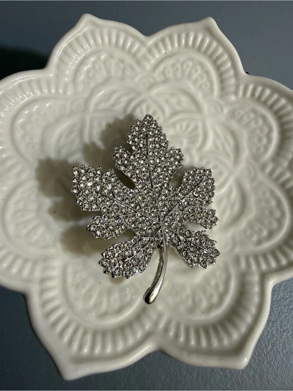 Sparkling silver-tone maple leaf brooches featuring pavé-set clear rhinestones.